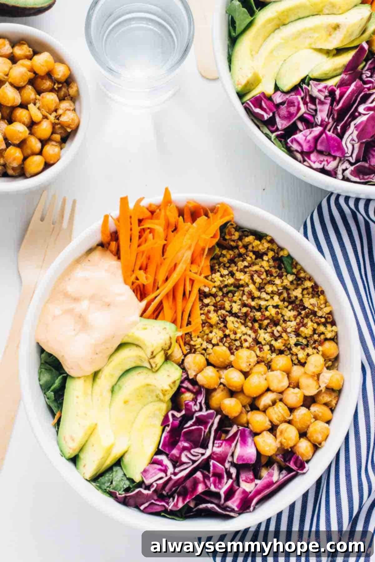 Nourishing Buddha Bowl with Harissa Tahini Dressing 4 Top down shot of two buddha bowls with a bowl of chickpeas on the side.