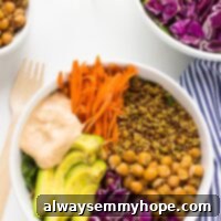 Nourishing Buddha Bowl with Harissa Tahini Dressing 8 Two nourish buddha bowls on a white table.