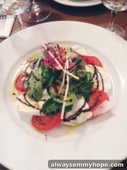 Unlocking Parisian Flavors 14 Tomato and mozzarella salad on a white dish.