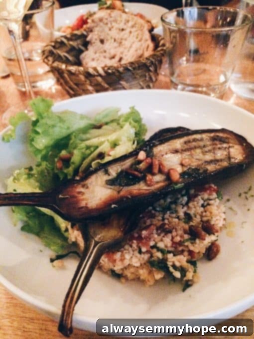 Unlocking Parisian Flavors 10 Grilled eggplant on a white plate in a restaurant.