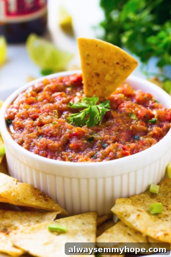 This easy restaurant-style blender salsa is made with fresh tomatoes for lots of bright flavour. Add your fave tortilla chips and dig in! Bowl of restaurant-style blender salsa with tortilla chip
