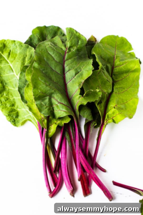 Top down shot of raw swiss chard on a white background. 