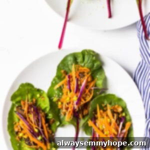 Overhead shot of swiss chard wraps on white plates.