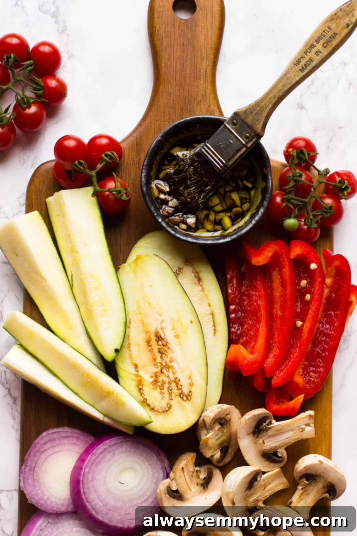 Raw vegetables on a cutting board with a brush in marinade