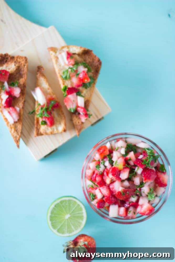 Strawberry salsa in a glass bowl, featuring fresh, diced strawberries.