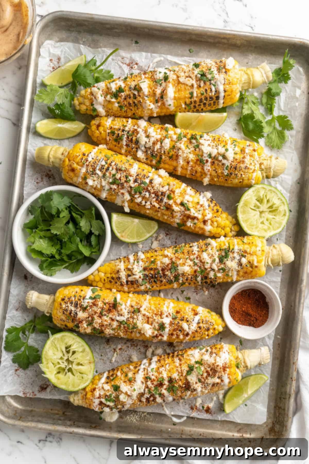 Ready-to-serve Vegan Elotes with Fresh Garnish. Overhead view of beautifully garnished Vegan Elotes on a sheet pan, ready to be served.