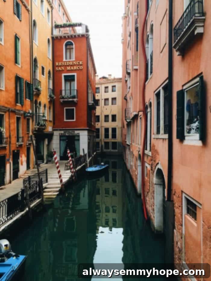 Glimpses of La Serenissima 6 A tranquil canal in Venice, with colorful buildings lining its banks, inviting exploration and discovery.