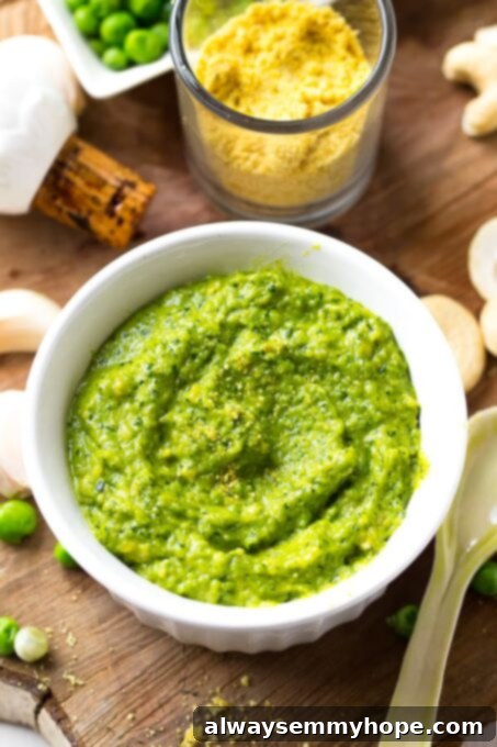 Top down shot of creamy cashew pea pesto in a white ramekin. 