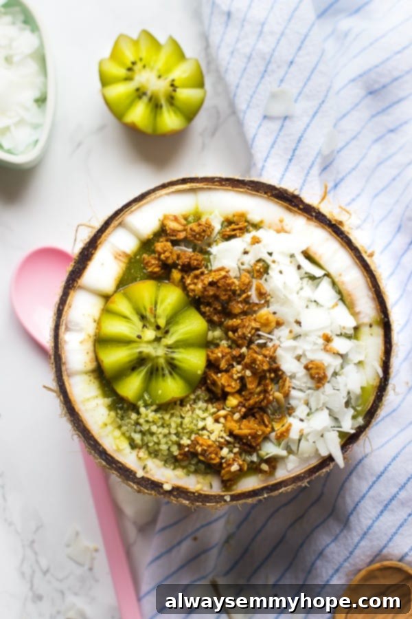 Tropical Coconut Kiwi Green Smoothie Bowl 2 Top down shot of coconut kiwi green smoothie bowl in a coconut.