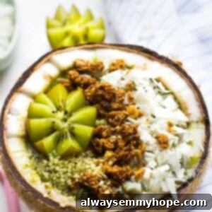 Tropical Coconut Kiwi Green Smoothie Bowl 7 A coconut kiwi green smoothie bowl in half a coconut.