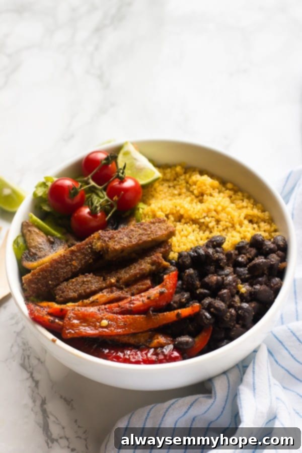 Vegan Fajita Bowls - 10-Minute Prep, High Protein 4 A vibrant vegan fajita bowl artfully placed beside a striped kitchen cloth, highlighting its freshness and delicious appeal.