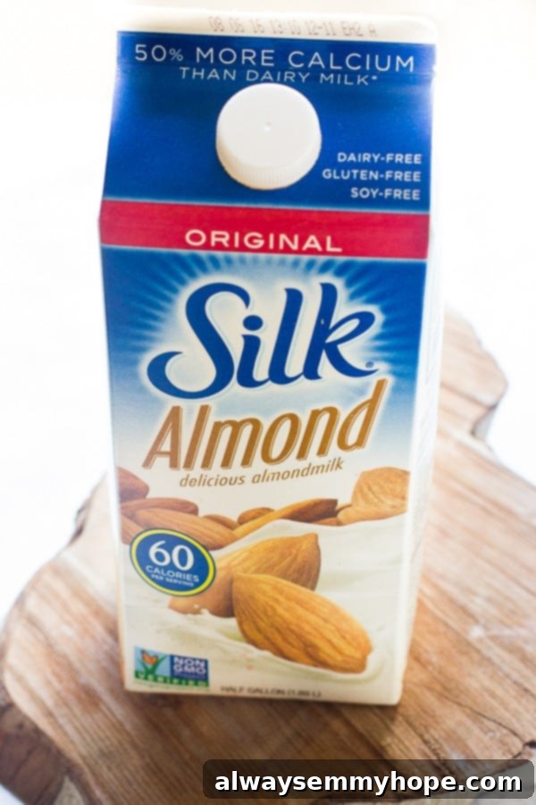 Mint Chocolate Chip Green Dream Smoothie 4 A carton of Silk Original Almondmilk stands on a warm wooden table, symbolizing a wholesome and plant-based ingredient for healthy recipes.