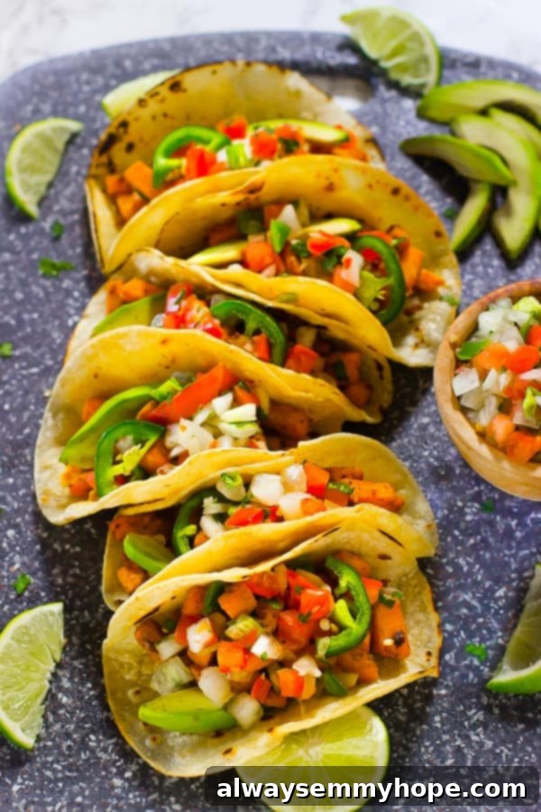 Terra's Kitchen: Sweet Potato Tacos Put to the Test 2 Top down shot of vibrant vegan sweet potato tacos with fresh lime wedges, ready to be enjoyed.