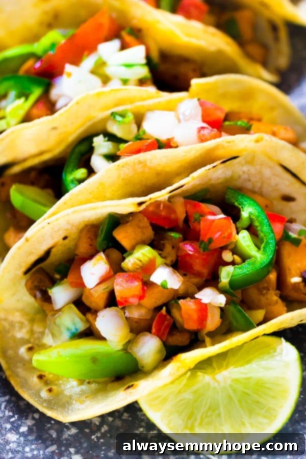 Terra's Kitchen: Sweet Potato Tacos Put to the Test 5 A close-up shot of a perfectly assembled vegan sweet potato taco, garnished with a vibrant lime wedge, emphasizing texture and freshness.