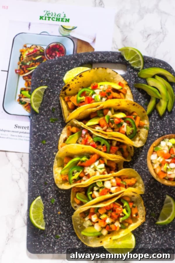 Terra's Kitchen: Sweet Potato Tacos Put to the Test 6 An overhead shot displaying multiple perfectly assembled sweet potato tacos arranged on a rustic chopping board, inviting a bite.