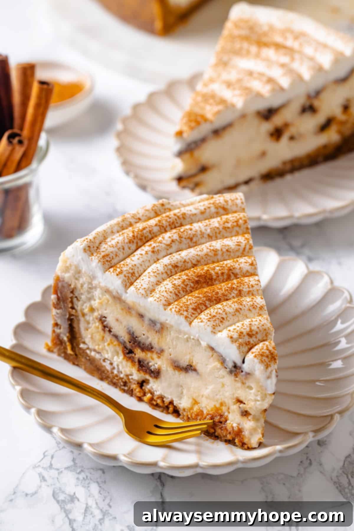 Two slices of vegan cinnamon roll cheesecake on plates