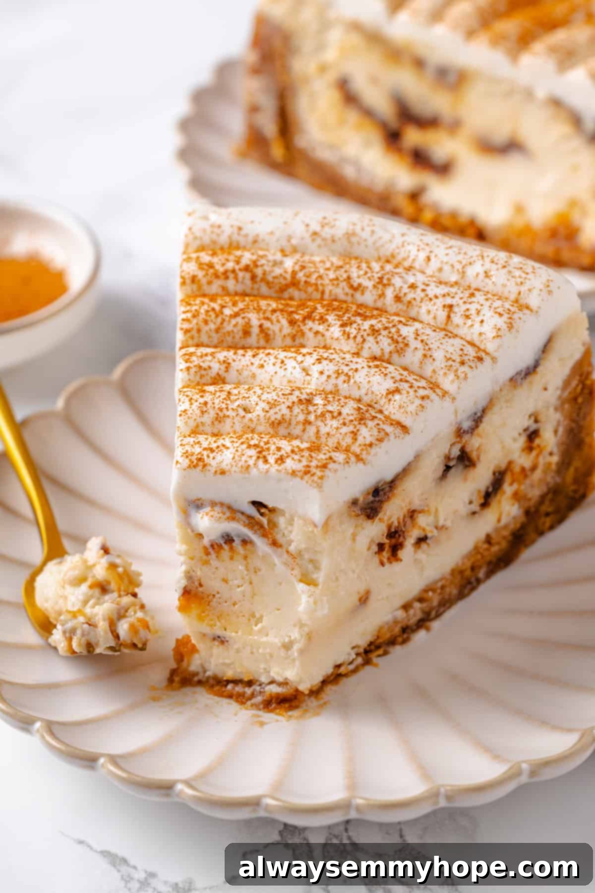 Slice of cinnamon roll cheesecake on plate with fork
