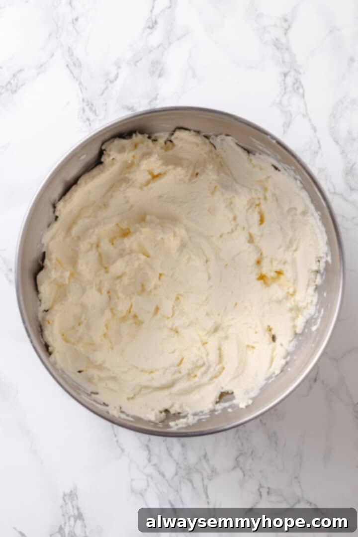 Beaten vegan cream cheese in mixing bowl