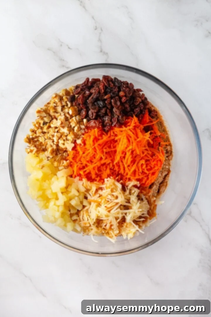 Ingredients for morning glory muffins in glass bowl.
