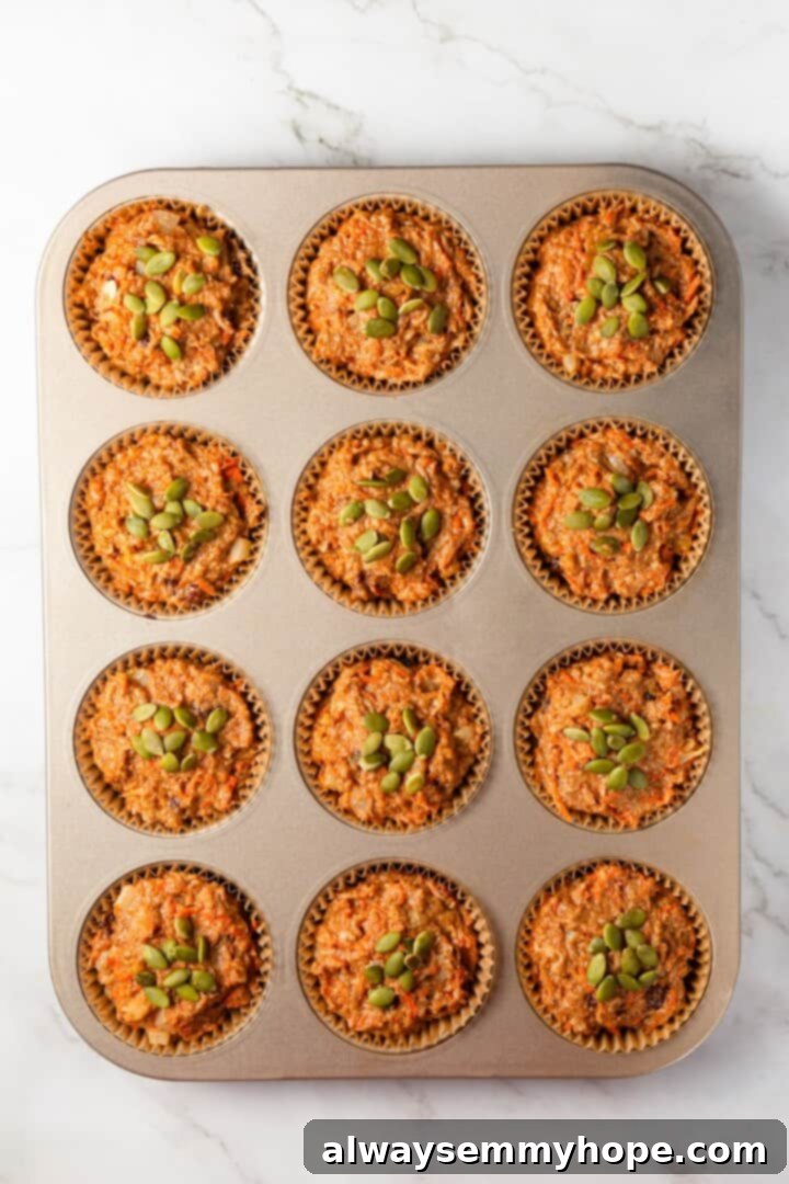 Overhead view of morning glory muffin batter in pan.