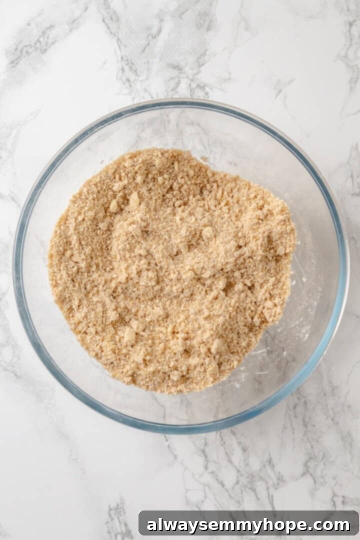 Crumb mixture in glass mixing bowl.