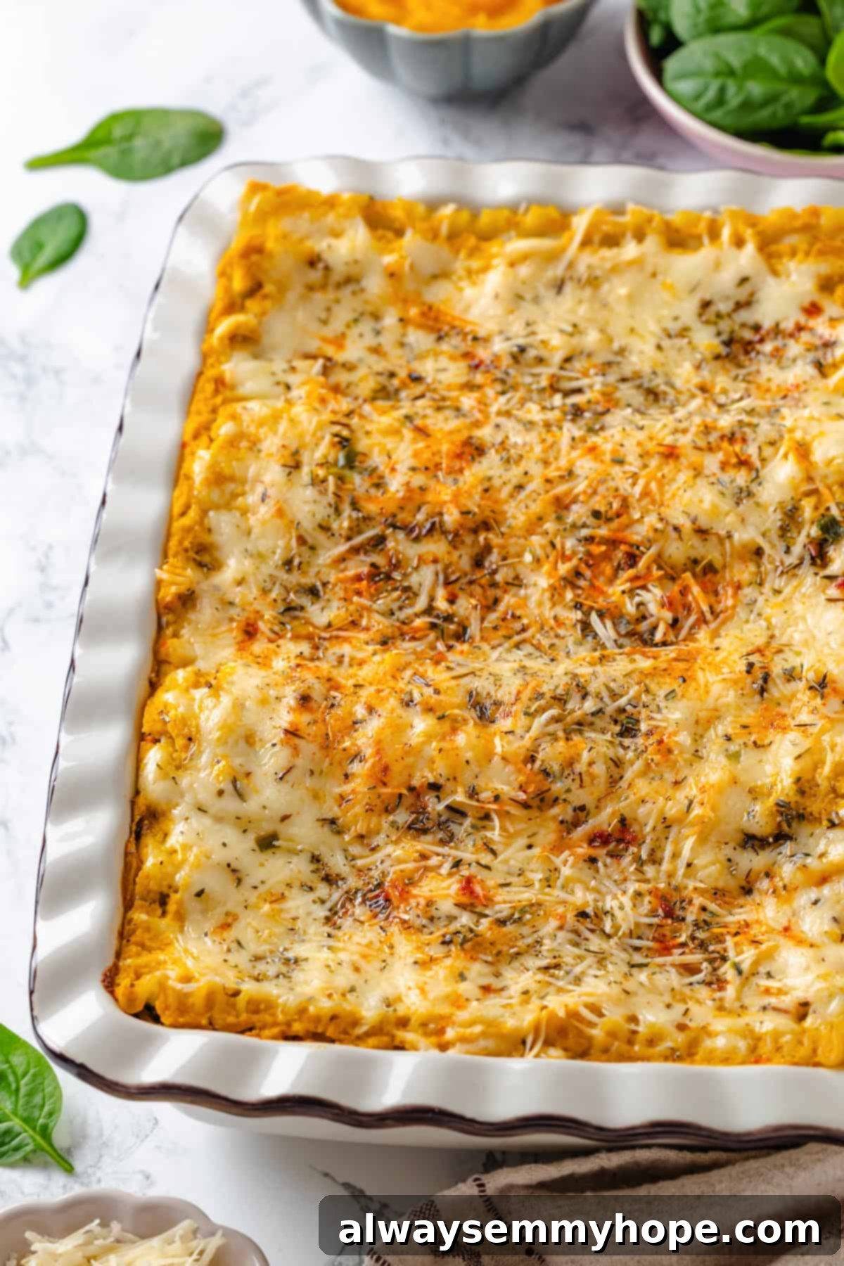 A perfectly baked butternut squash lasagna in a baking dish, ready to be sliced and enjoyed.