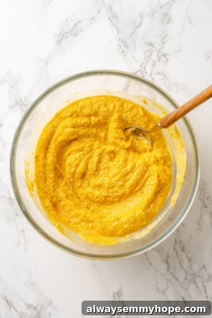 Butternut squash mixture in a bowl, perfectly blended with vegan ricotta, milk, and seasonings to create a harmonious flavor profile.