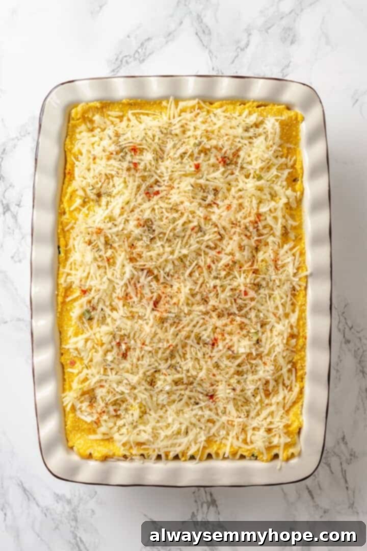 Vegan cheese generously sprinkled on top of the butternut squash lasagna, promising a golden and bubbly finish.
