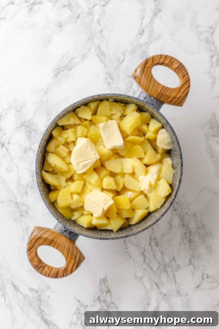 Butter added to a pot of potatoes.