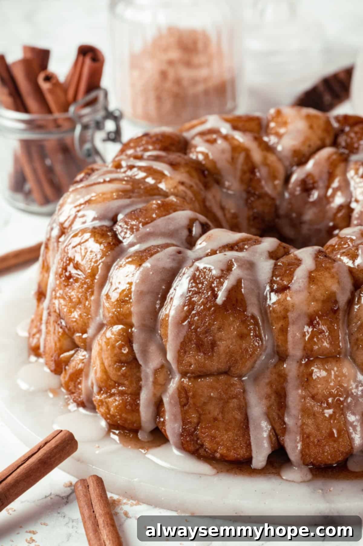 Glazed vegan monkey bread on a marble platter, showcasing its pull-apart texture and glistening glaze.
