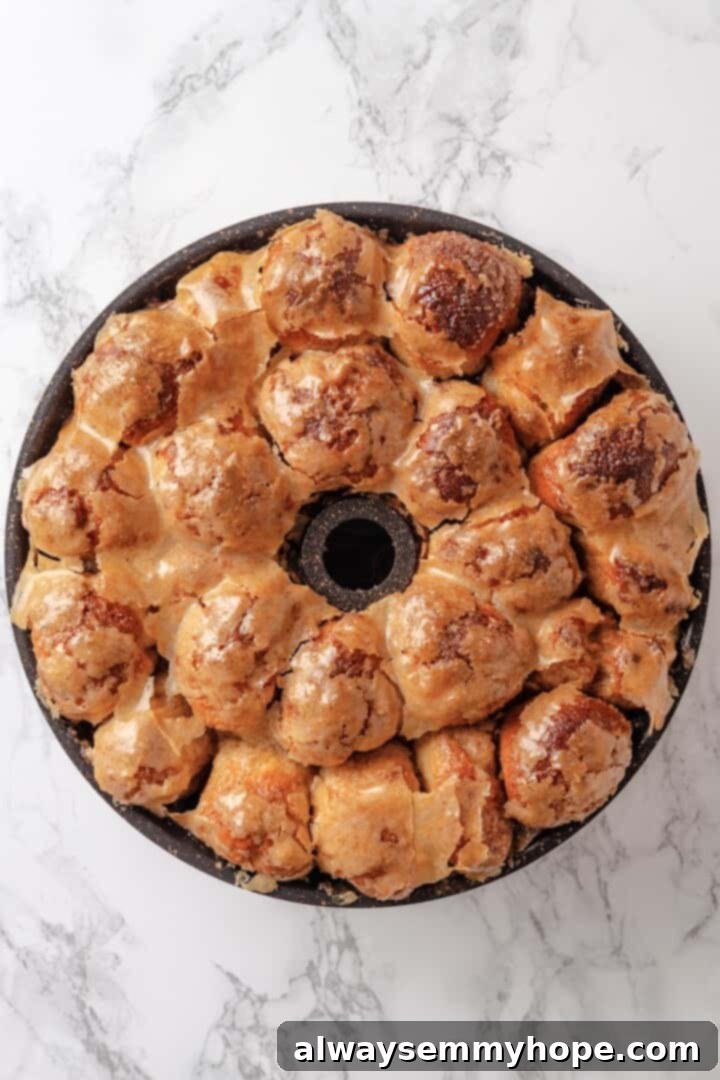 Baked vegan monkey bread in a bundt pan, fresh from the oven, showing its golden-brown color and bubbly surface.
