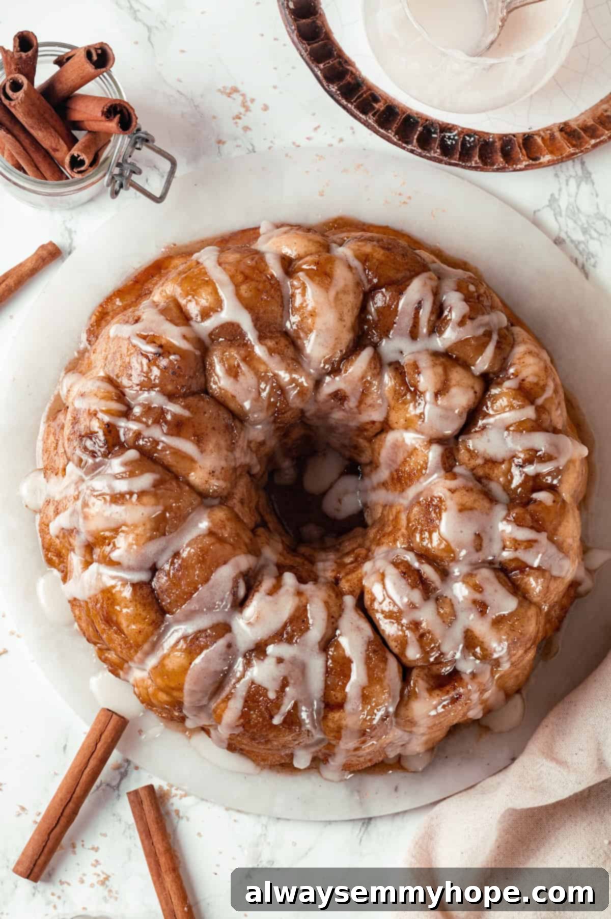 Glazed vegan monkey bread on a marble board, showcasing its gooey texture and delectable appearance.