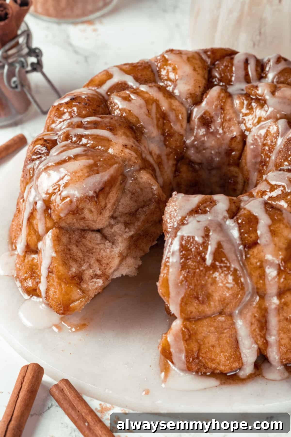 Vegan monkey bread served on a platter, with pieces pulled apart to reveal its soft, gooey, and cinnamon-sugar-filled interior.