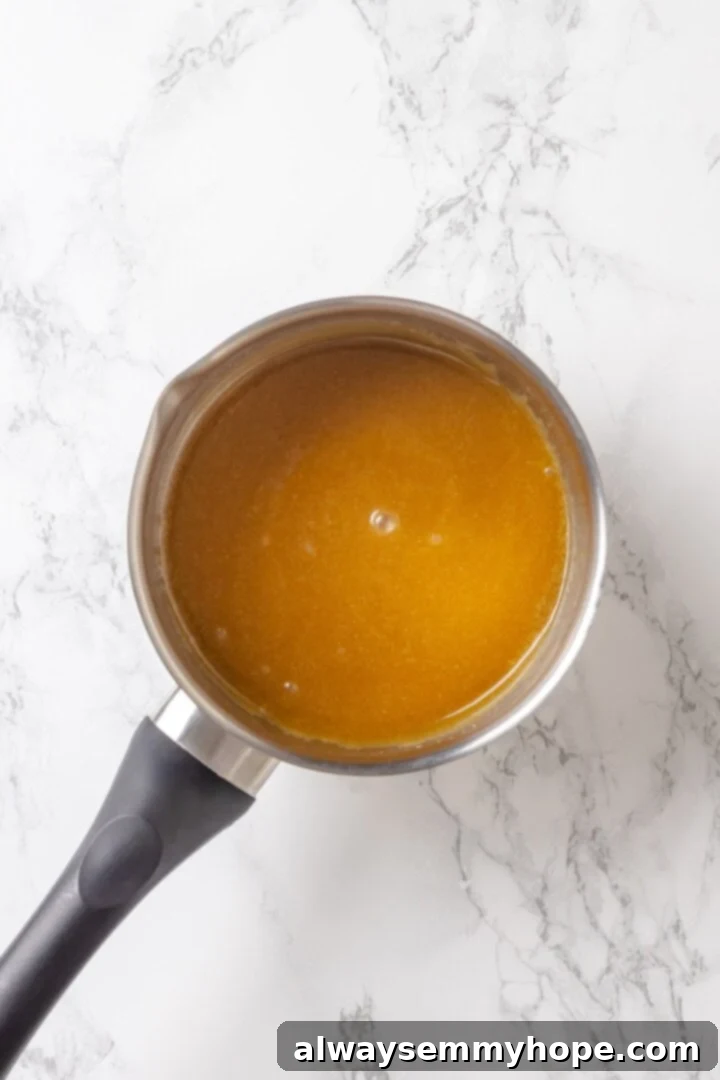The caramel mixture for vegan monkey bread being prepared in a saucepan, ready to be poured over the dough.