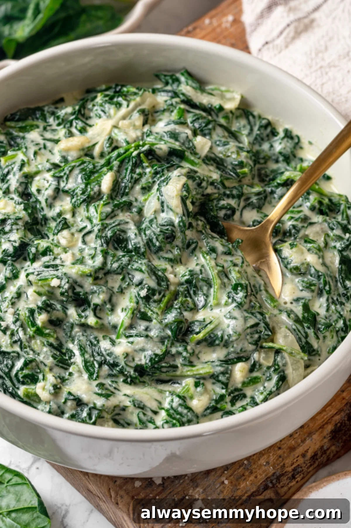 Vegan creamed spinach in a bowl with a spoon.
