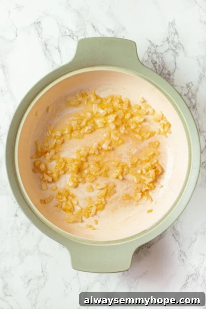 Onion and garlic cooking in a skillet.