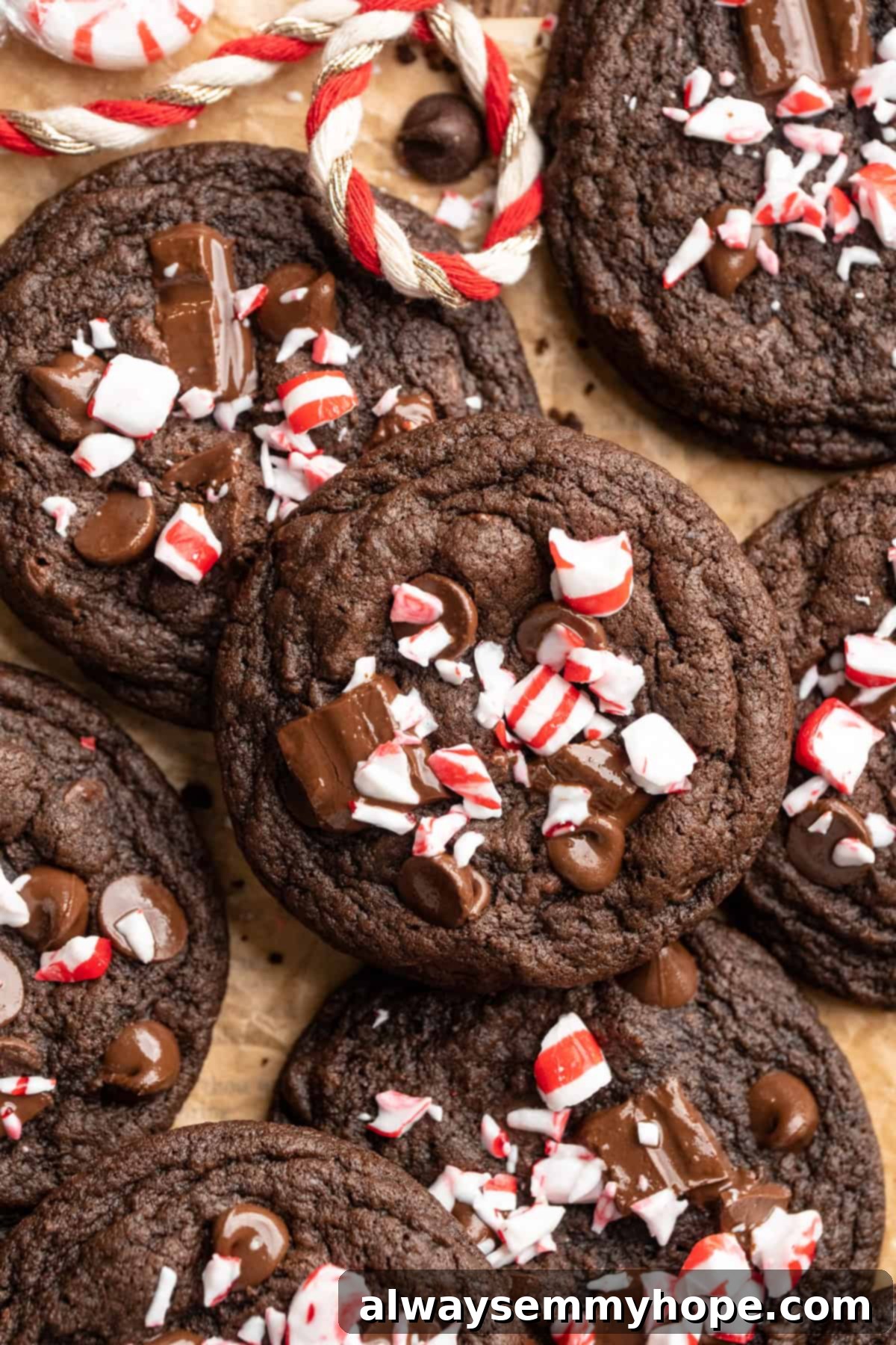 Chewy peppermint chocolate cookies piled on parchment paper.