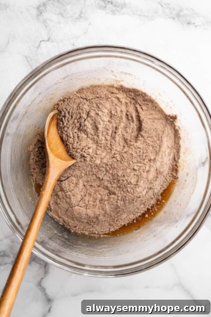 Dry ingredients added to bowl of wet ingredients.