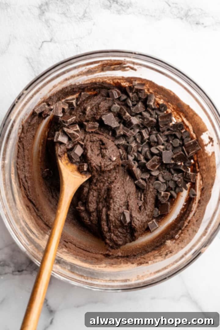 Chocolate chunks added to cookie dough.