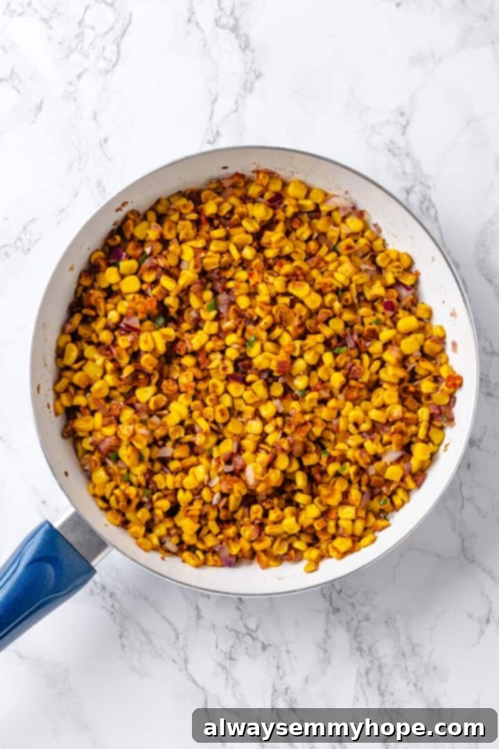 Charred corn in skillet with aromatics