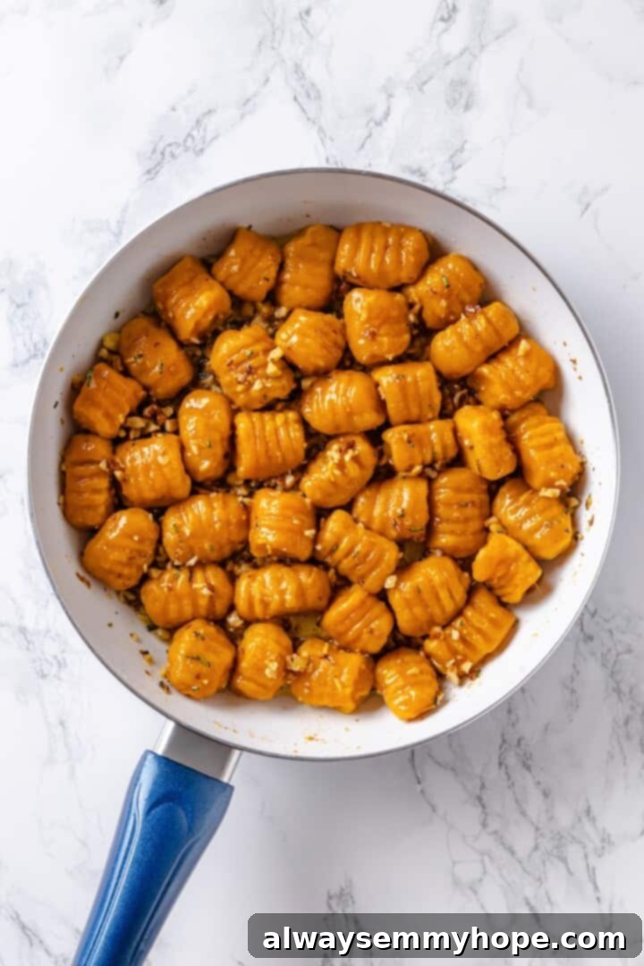 Sweet potato gnocchi in skillet with butter sauce.