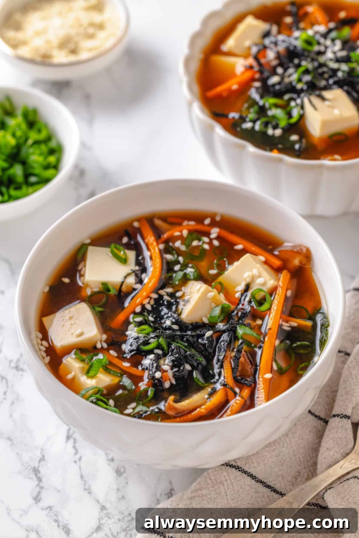 Two bowls of miso soup with tofu.