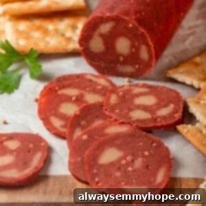 Slices of vegan salami on wooden board.