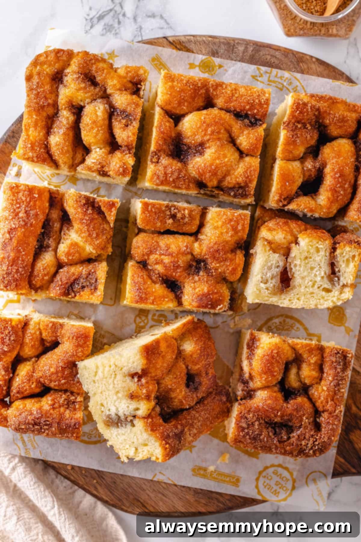 Sliced Moravian sugar cake on parchment-lined wooden board