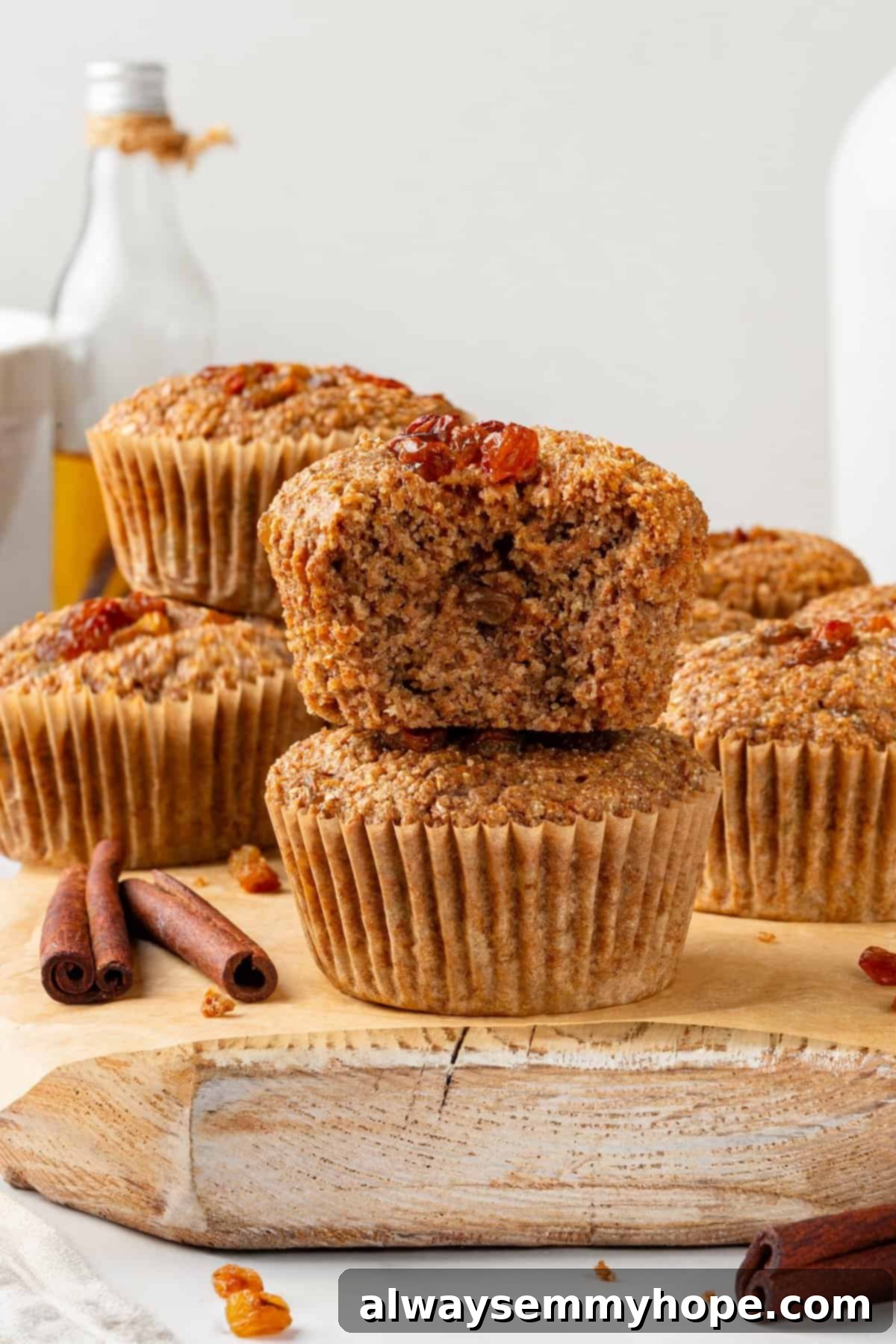 Close-up of a vegan bran muffin with a bite taken out, showing the tender crumb.