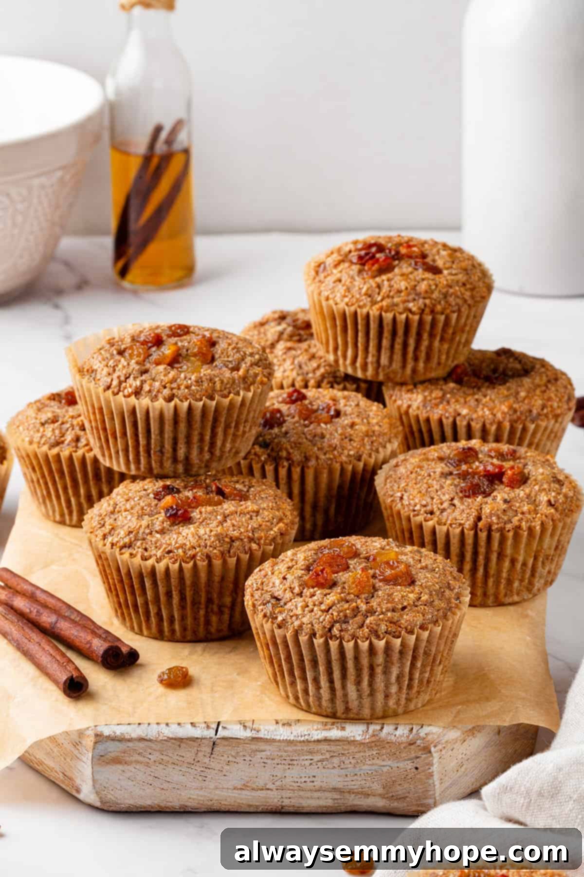 Stack of vegan bran muffins on a wooden board, ready to be enjoyed.