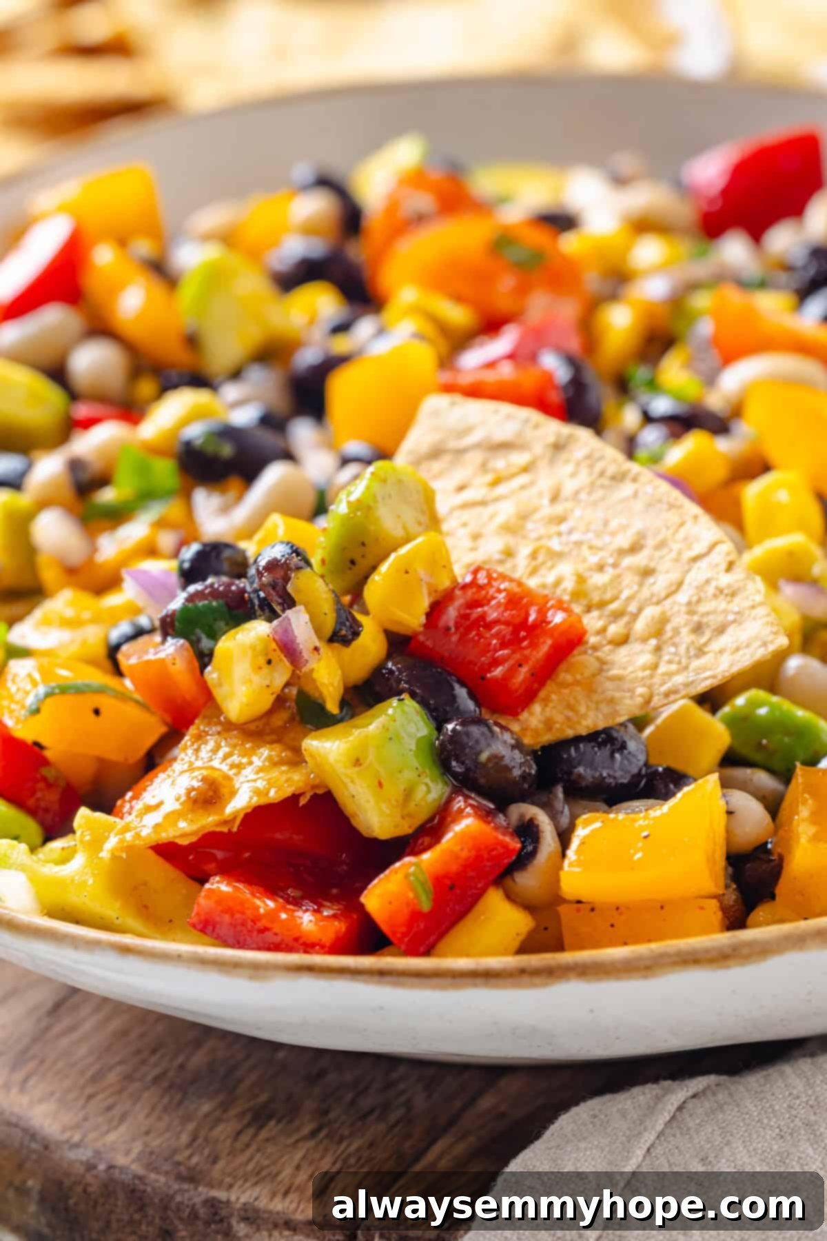 Tortilla chip dipped in cowboy caviar.