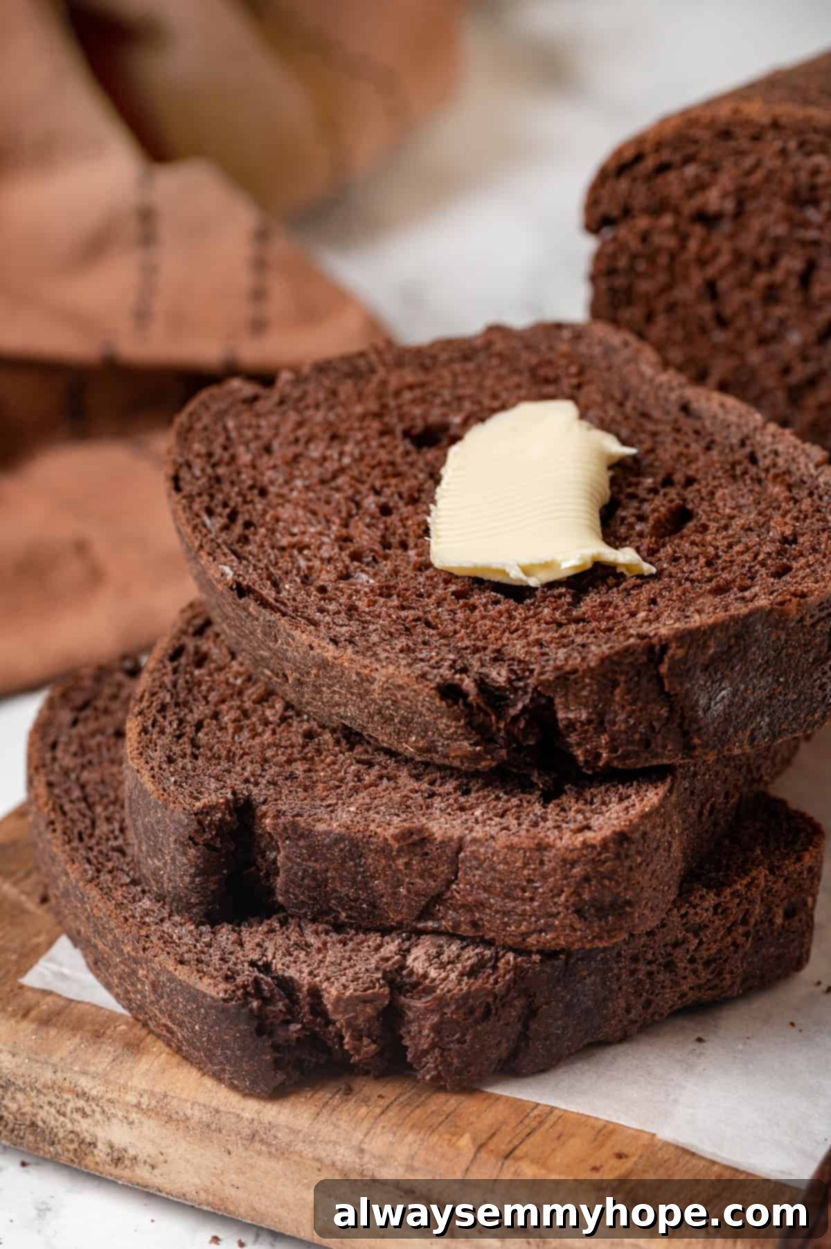 Pumpernickel Bread: A Deep Dive into Flavor and Tradition 2 Slices of homemade pumpernickel bread with butter