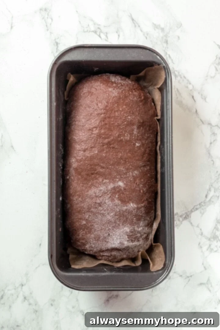 Pumpernickel Bread: A Deep Dive into Flavor and Tradition 7 Baked loaf of pumpernickel bread in a pan