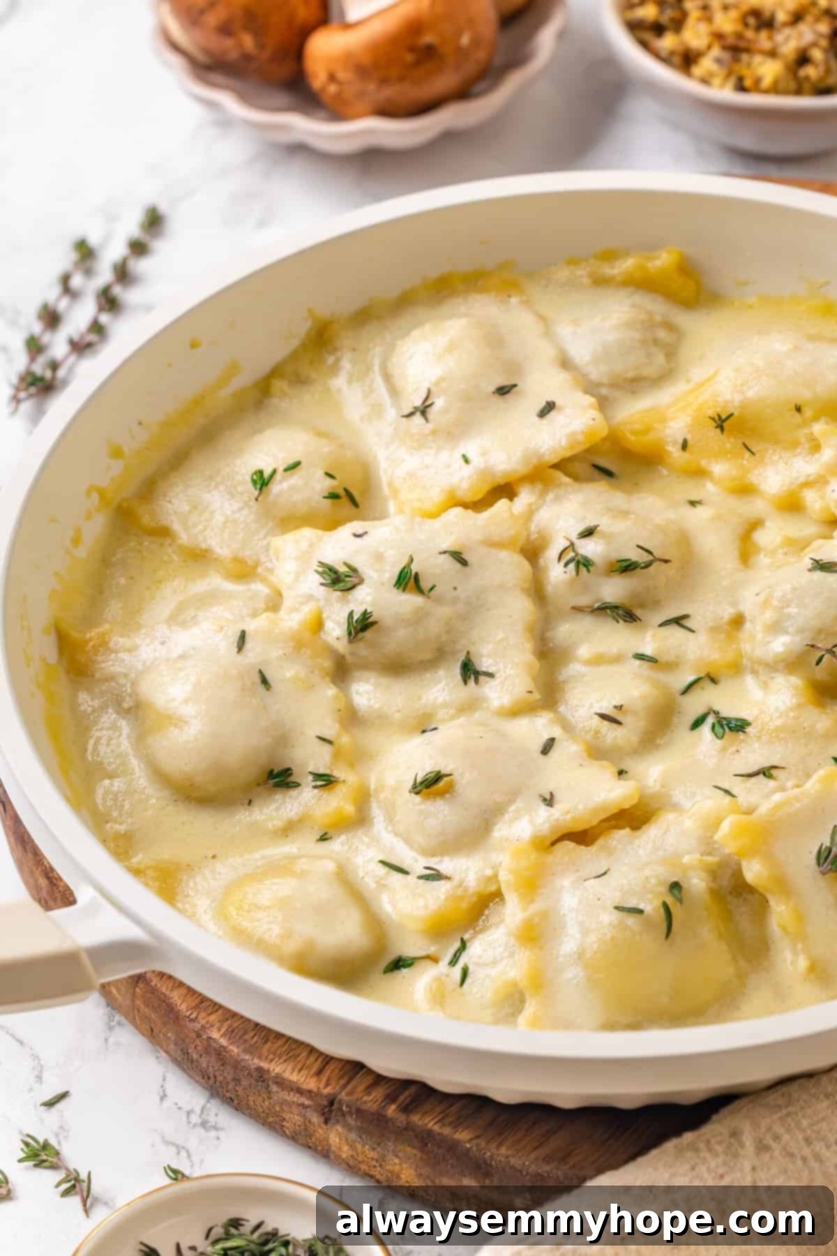 Mushroom Ravioli Delight 2 Pan of mushroom ravioli with vegan parmesan sauce and thyme.